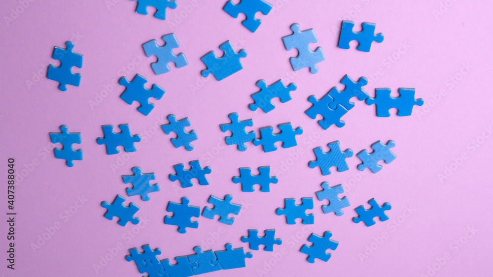 scattered puzzle pieces on colored background scattered puzzle pieces on colored background