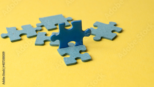 scattered puzzle pieces on colored background
