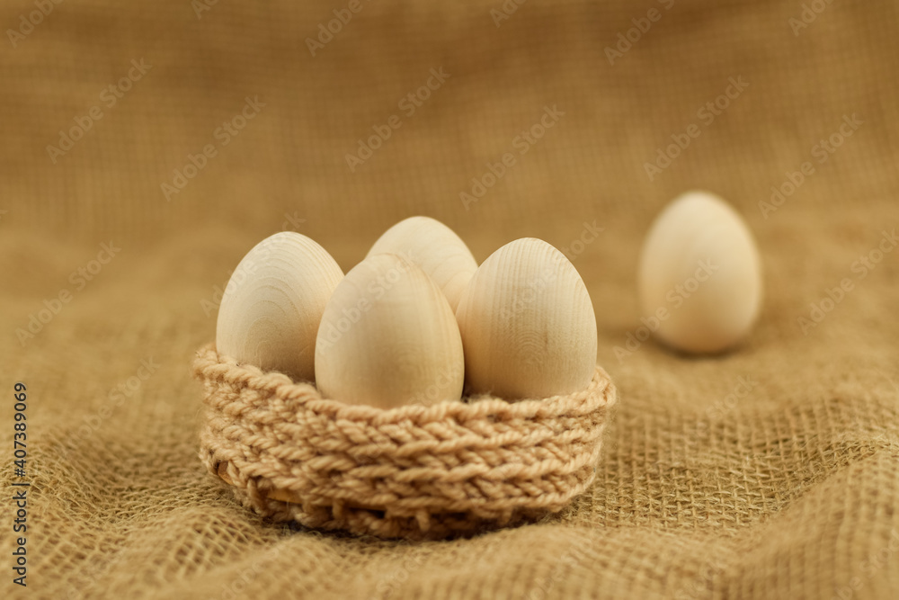 Decorative wooden Easter eggs in a wicker basket. Eastern eggs closeup on a vintage background. Decorative wooden Easter eggs in a wicker basket. Eastern eggs closeup on a vintage background.