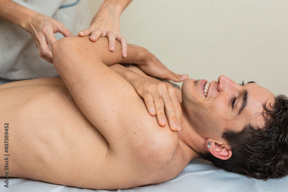 Fototapeta premium physiotherapist does session to man. dorsal manipulation, thrust, lumbar roll