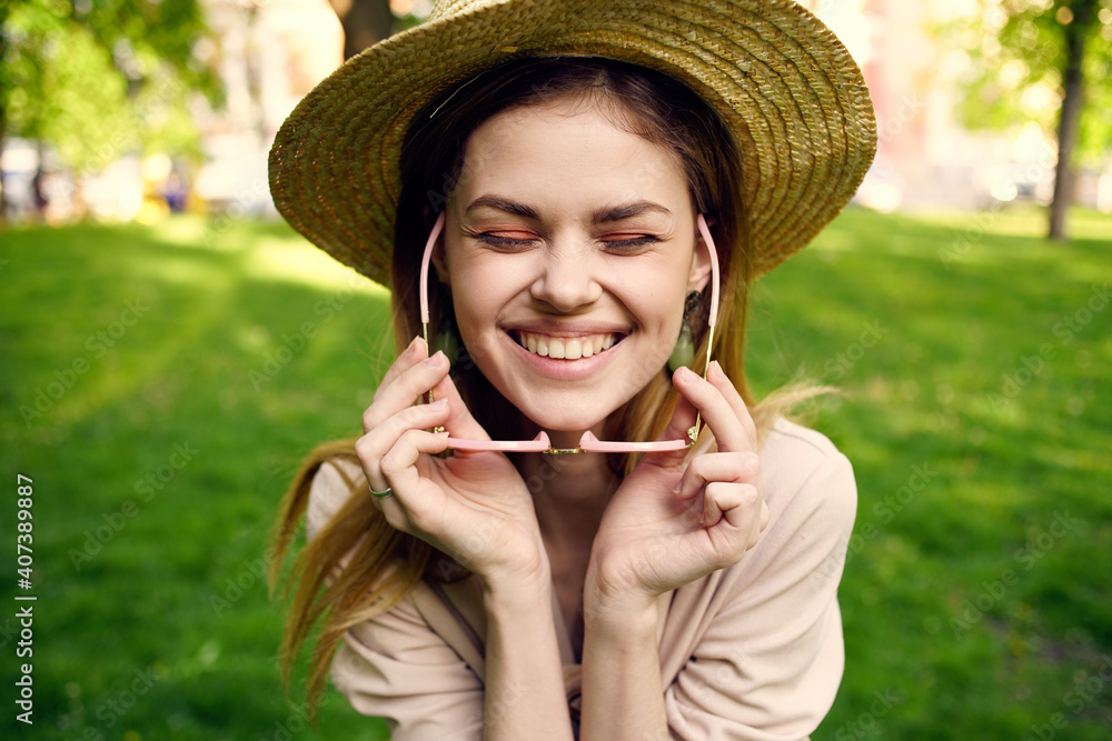 Cheerful woman in the park fresh air travel green grass walk outdoors