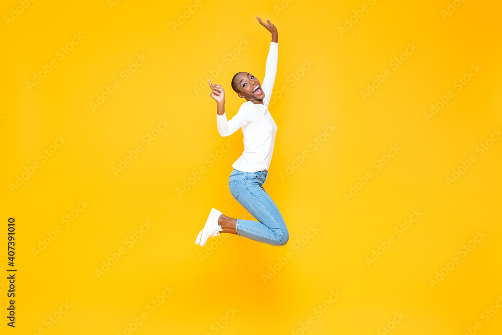 Happy excited African American woman jumping with hands raising in ...