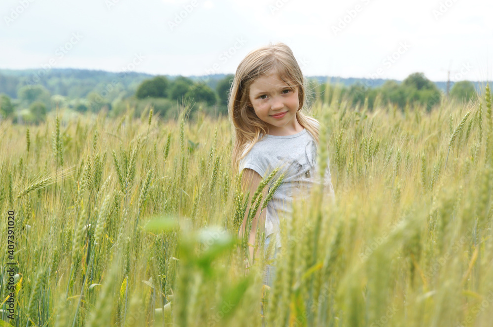 a girl in a field of rye cornflowers in the summer