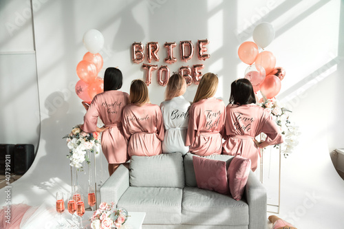 Canvastavla Bride with girlfriends in silk robes at a bachelorette party.