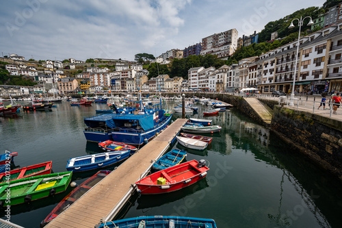 The Austurian port village of Luarca showing boats in harbor and tourists on promenade photo