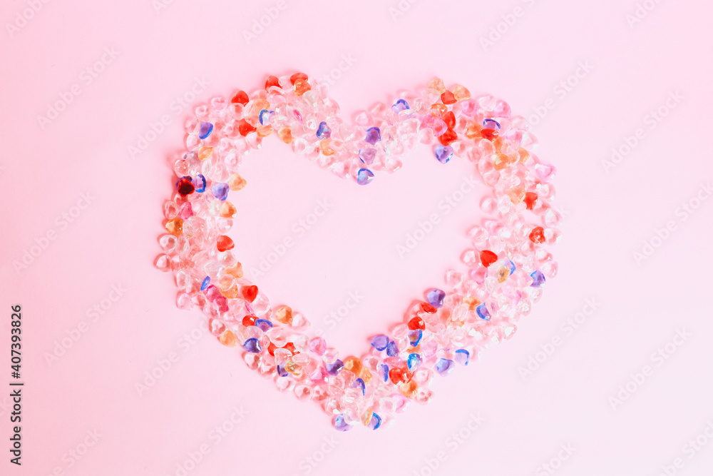 Colorful heart shape marbles isolated on pink background