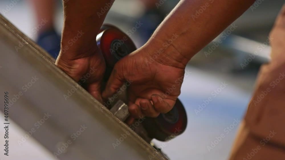 Crew member preparing a camera dolly in a television studio. Close up shot. Crew member preparing a camera dolly in a television studio. Close up shot.