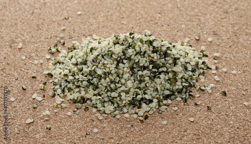 Peeled hemp seeds on cork mat, plug surface background and texture  photo