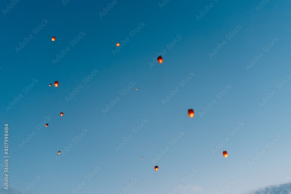 releasing flying lanterns at dusk releasing flying lanterns at dusk
