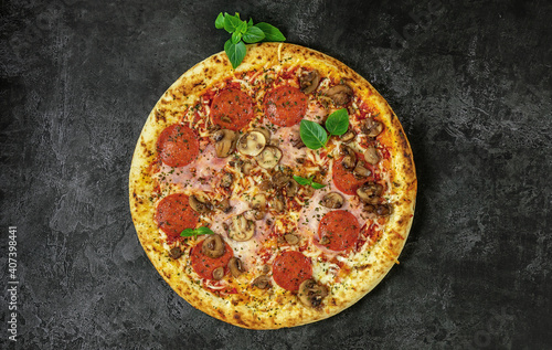 Whole neapolitan pizza served on dark board