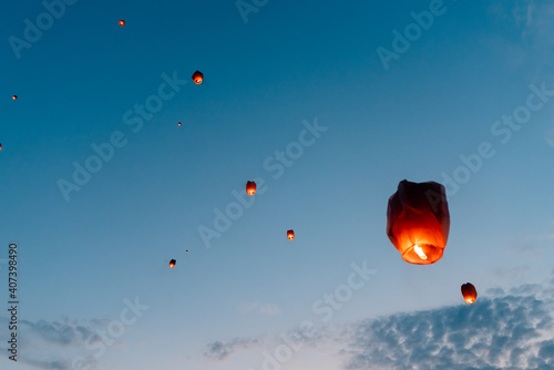 releasing flying lanterns at dusk