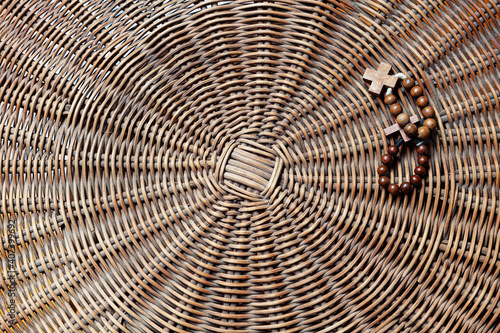 Detail of a top of a woven wicker table with two Rosary Crowns