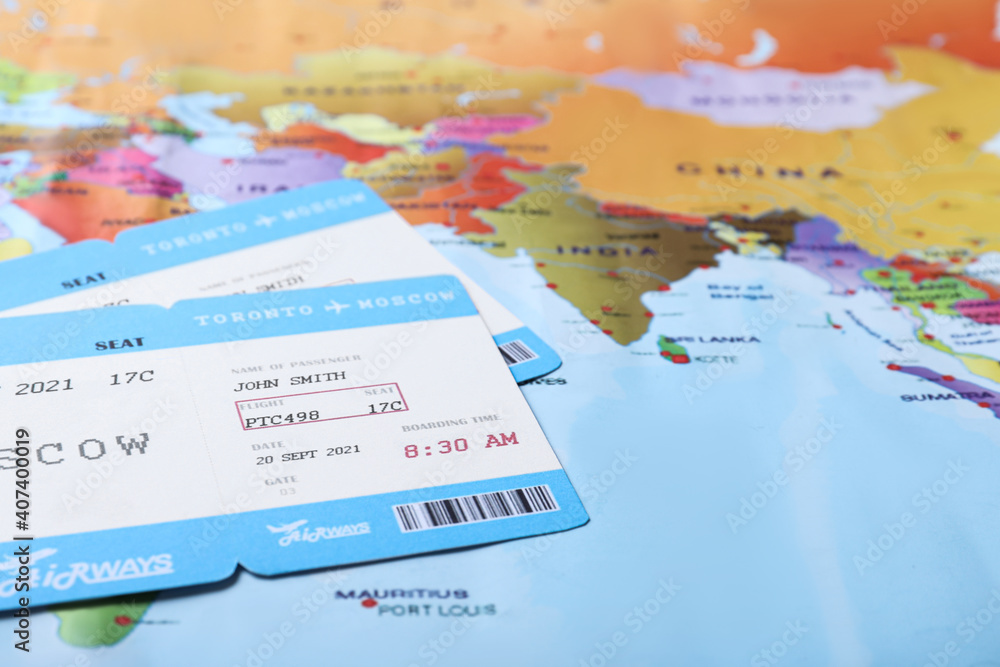 Naklejka premium Avia tickets on world map, closeup. Travel agency concept