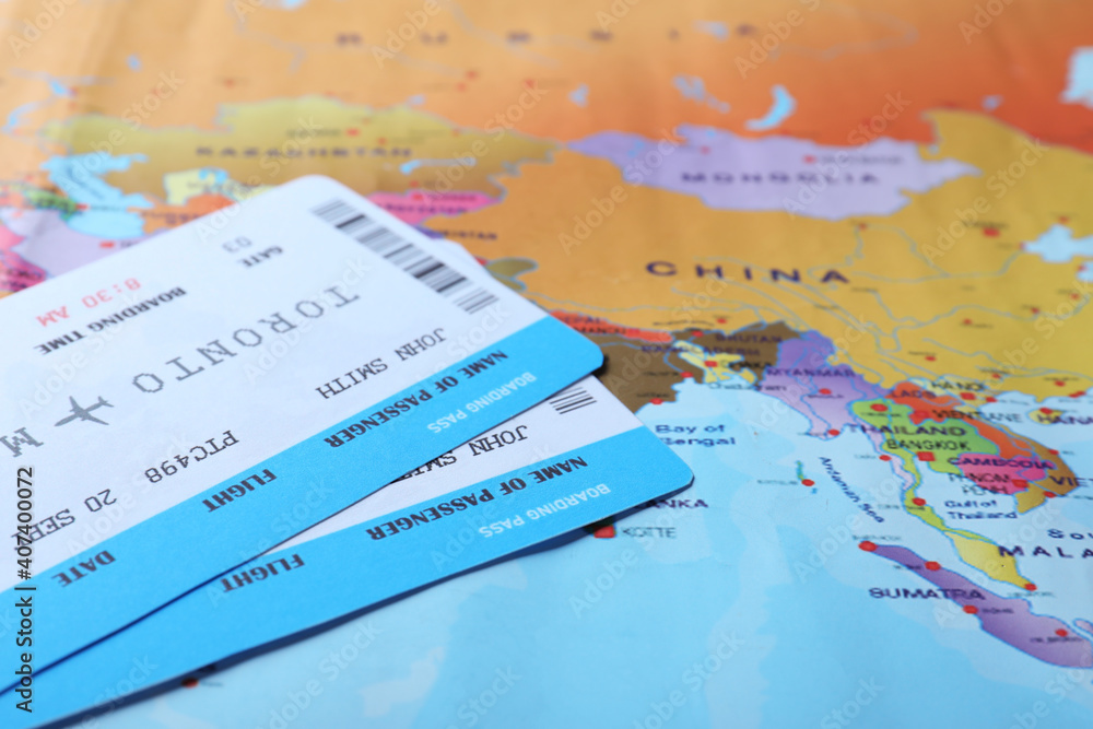 Avia tickets on world map, closeup. Travel agency concept