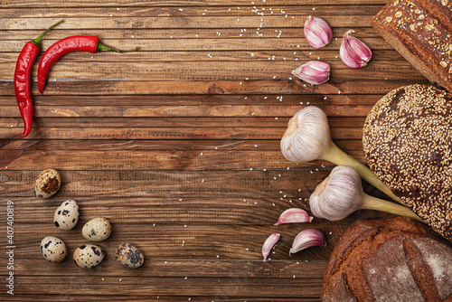 red pepper, hot garlic, fresh crispy bread and quail eggs on the kitchen table