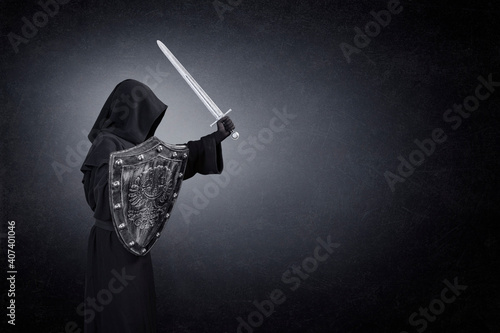 Ghostly figure with medieval sword and shield in the dark photo