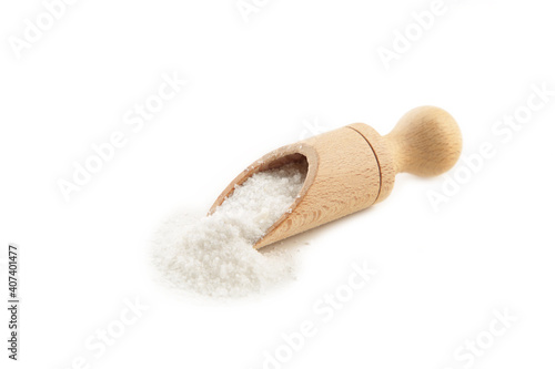 Regular table salt in a wooden spoon isolated on white background