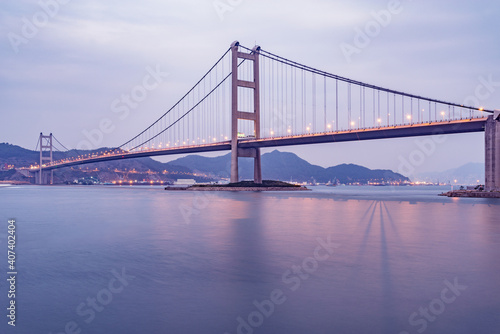 Suspension bridge to Park island at sunset. © serjiob74