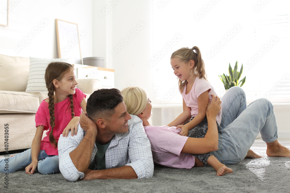 Happy family with children on floor at home Happy family with children on floor at home