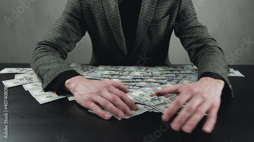 Wallpaper Mural Greedy businessman man takes money from the table for his own benefit. Money accumulation concept. Torontodigital.ca