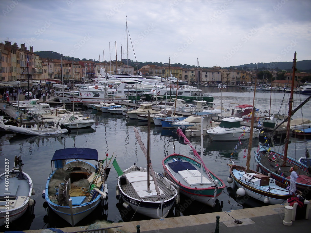 Saint Tropez, France - Contrast between the exclusive yachts and the small wooden fisher boats.