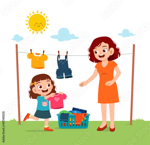 little kid helping mother to dry the clothes outside