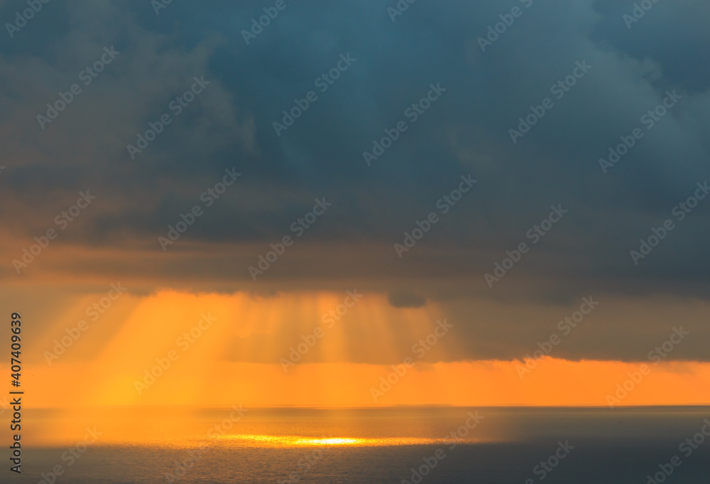 Sunbeams in the sea breaking through the clouds.Concept elements of Nature