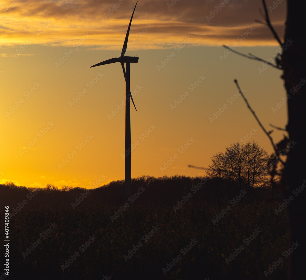 Black Silhouette of windturbines energy generator on amazing sunset at a wind farm in langenberg, germany Black Silhouette of windturbines energy generator on amazing sunset at a wind farm in langenberg, germany