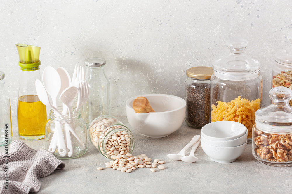 kitchen utensils on modern simple counter, kitchenware jars with dry ingredients bowls kitchen utensils on modern simple counter, kitchenware jars with dry ingredients bowls
