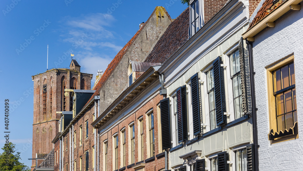 Fototapeta premium Row of houses and church tower in historic town Elburg, Netherlands
