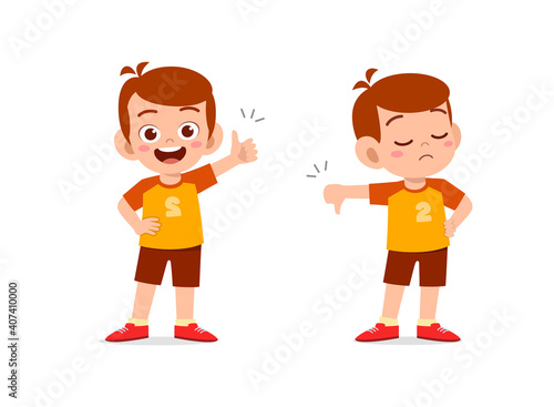 little boy show hand gesture thumb up and thumb down