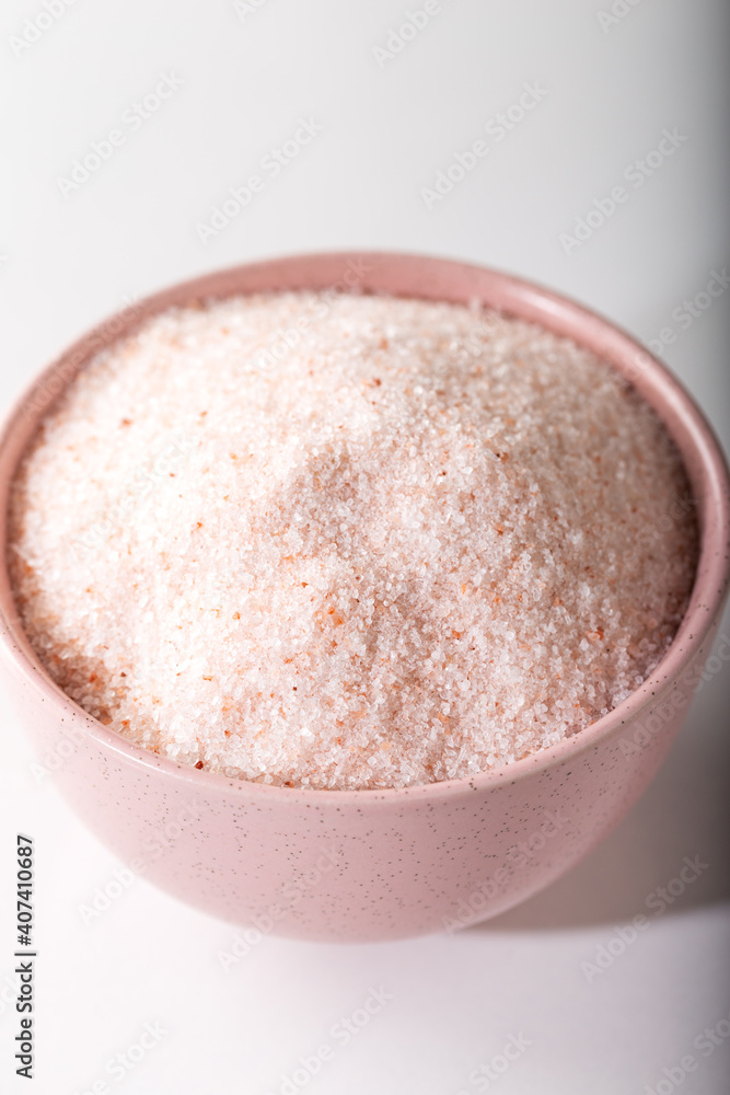 Powder Himalayan pink salt in pink bowl. Food background. Powder Himalayan pink salt in pink bowl. Food background.