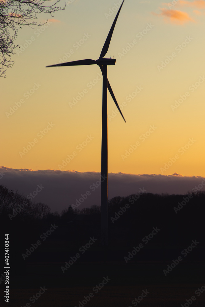 Obraz premium Black Silhouette of windturbines energy generator on amazing sunset at a wind farm in langenberg, germany