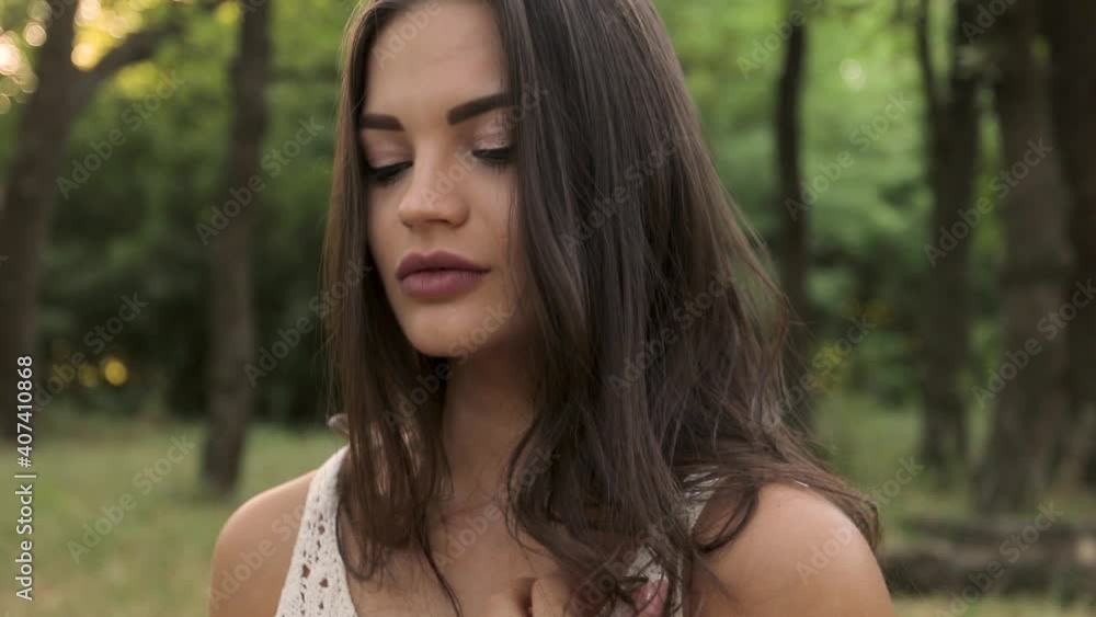 girl sexually runs her hand along her neck and straightens her hair, portrait, white dress on a beautiful brunette, green forest, basket of peaches on a blanket, model sits on the lawn. snapshots, slo girl sexually runs her hand along her neck and straightens her hair, portrait, white dress on a beautiful brunette, green forest, basket of peaches on a blanket, model sits on the lawn. snapshots, slo