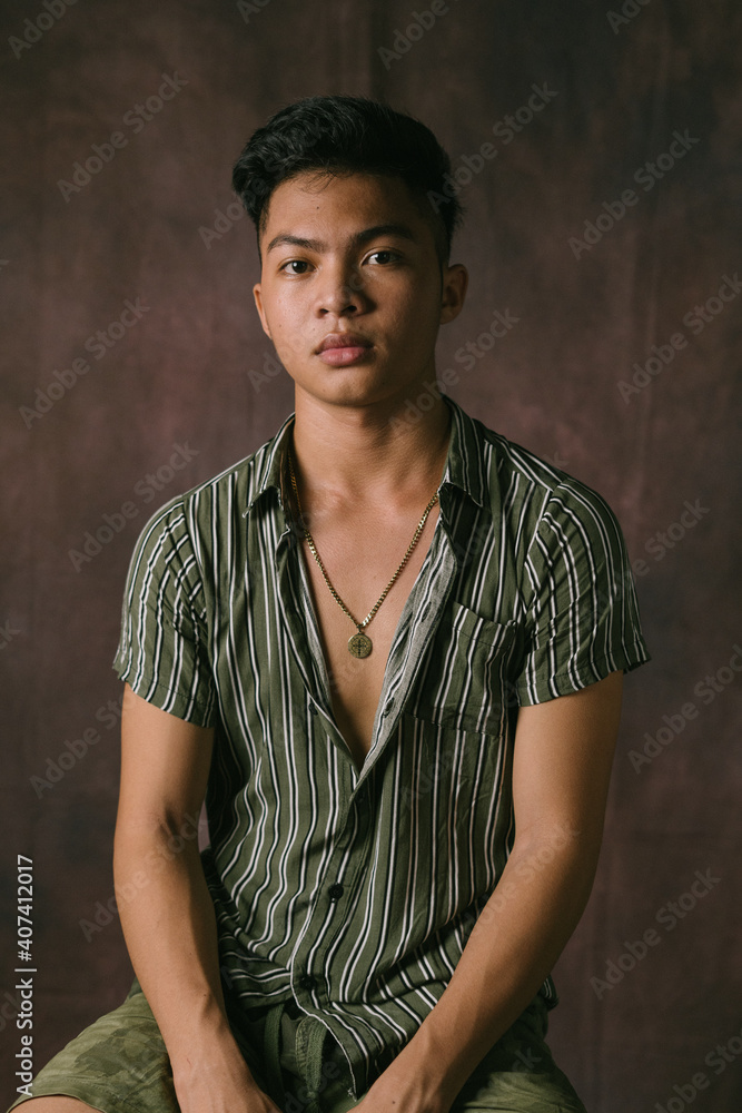 Amazing Portrait Shot a Handsome Filipino Male Model in the Philippines. Serious Asian Guy Posing at the Studio, Looking at the Camera, Posing Isolated over Studio Backdrop Background Amazing Portrait Shot a Handsome Filipino Male Model in the Philippines. Serious Asian Guy Posing at the Studio, Looking at the Camera, Posing Isolated over Studio Backdrop Background