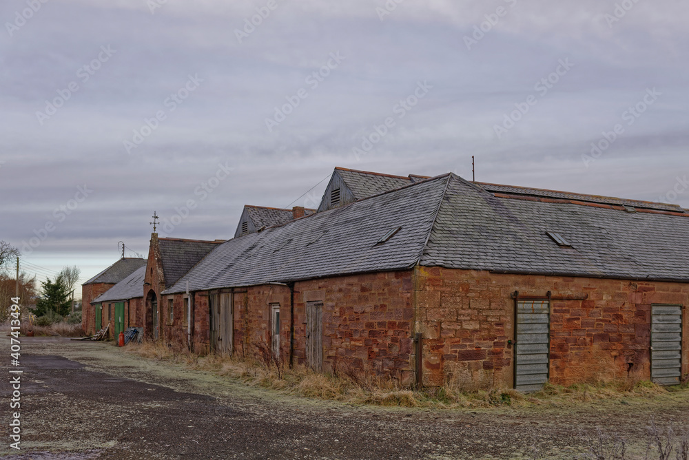 Obraz premium An old Victorian ruined Barn and Agricultural Store Complex , all shut up near to Letham Grange on the East Coast of Scotland.