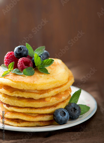 Stack of pancakes with fresh berries, close-up.