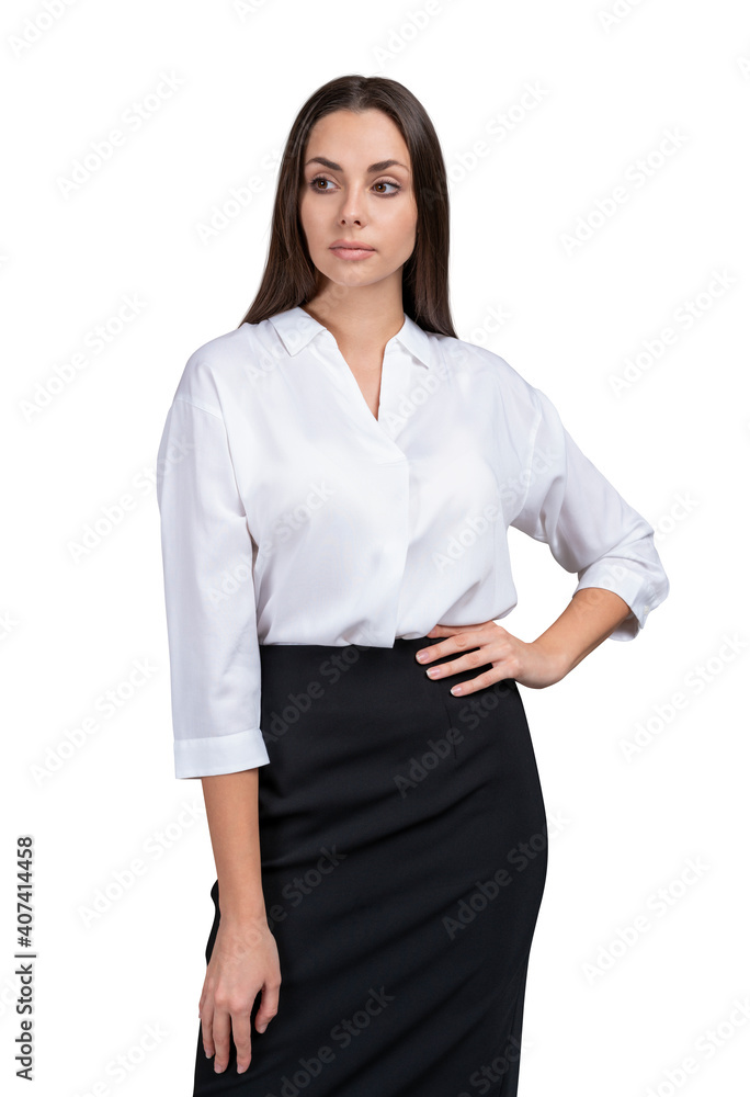 Young businesswoman in white shirt and skirt, long hair. Standing isolated over white background, looking away hand on the waist Young businesswoman in white shirt and skirt, long hair. Standing isolated over white background, looking away hand on the waist