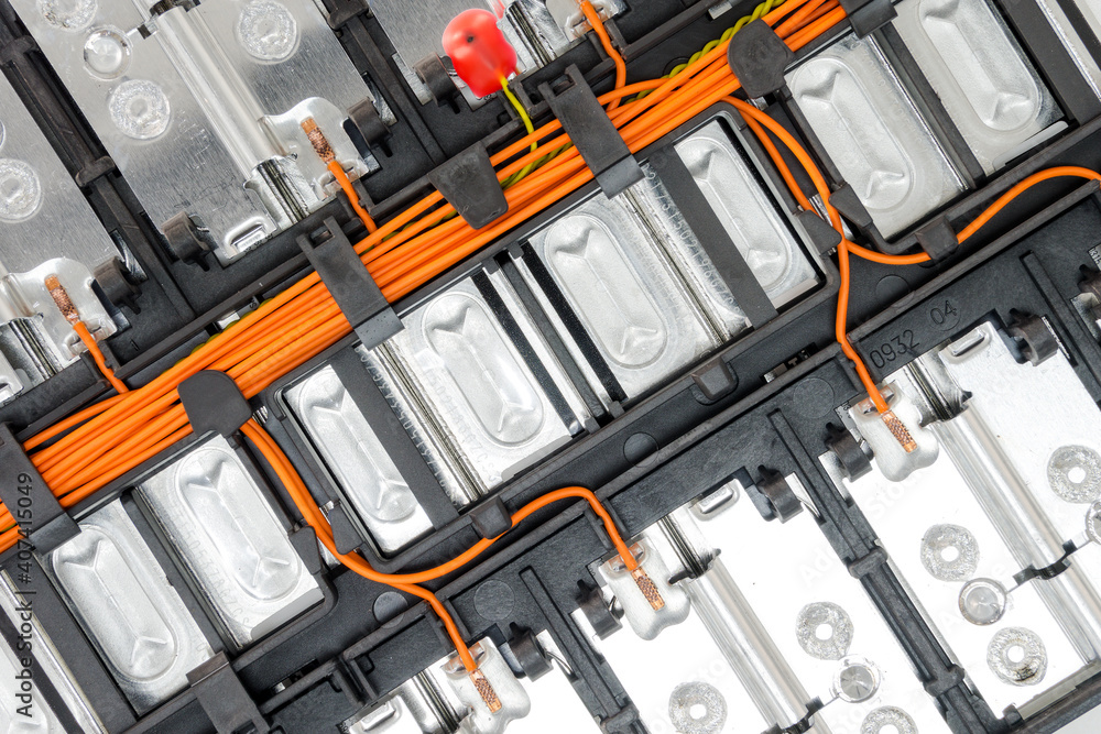 Selective focus of Electric car lithium battery pack and wiring connections internal between cells on background.	