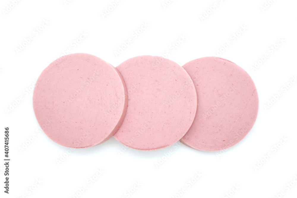 Sliced sausage isolated on white background. Fresh cut boiled pieces. Three slices. Top view. Sliced sausage isolated on white background. Fresh cut boiled pieces. Three slices. Top view.