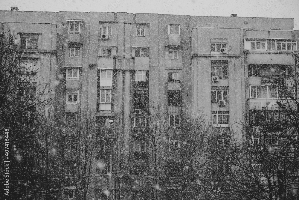 Fototapeta premium Block in Bucharest in the cold season, snow in Bucharest, black and white photography.