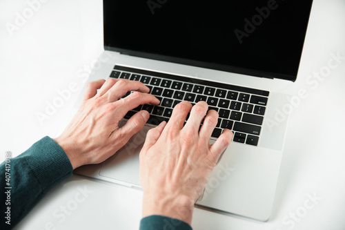 close up. casual male typing on a laptop keyboard.