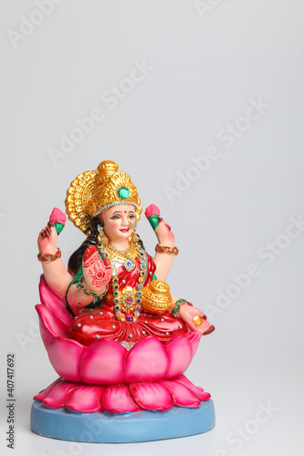 Beautiful Clay Idol of Hindu Goddess Lakshmi OR Laxmi on white background