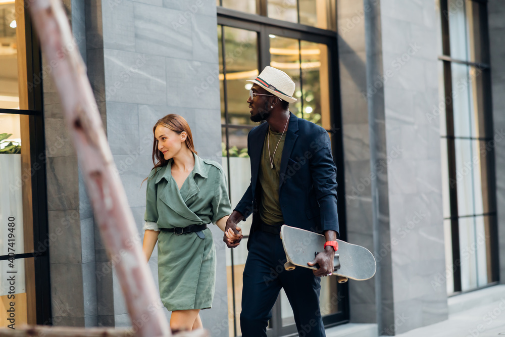 Portrait of beautiful woman and handsome afro man in dark blue color suit and hat hipster and vintage style and skateboarding Portrait of beautiful woman and handsome afro man in dark blue color suit and hat hipster and vintage style and skateboarding