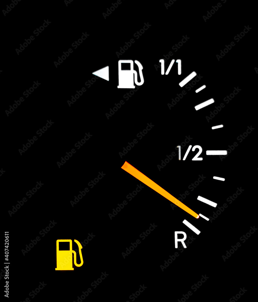 Fuel indicator on a cars dashboard showing no gas in tank. Fuel indicator on a cars dashboard showing no gas in tank.
