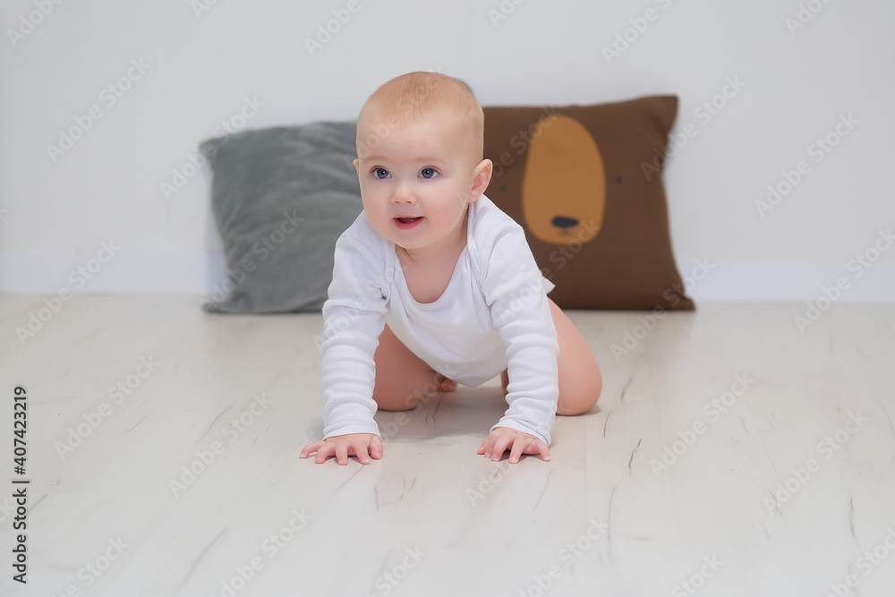 Cute small toddler baby child crawl on warm wooden home floor. Smiling little infant kid play in children room indoors, explore world. Childcare, upbringing concept. Cute small toddler baby child crawl on warm wooden home floor. Smiling little infant kid play in children room indoors, explore world. Childcare, upbringing concept.