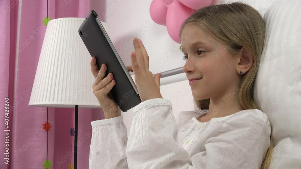 Kid Playing Tablet in Bed, Child Browsing Internet on Touchscreen Smartphone, Girl Portrait Not Sleeping Relaxing on PC Kid Playing Tablet in Bed, Child Browsing Internet on Touchscreen Smartphone, Girl Portrait Not Sleeping Relaxing on PC