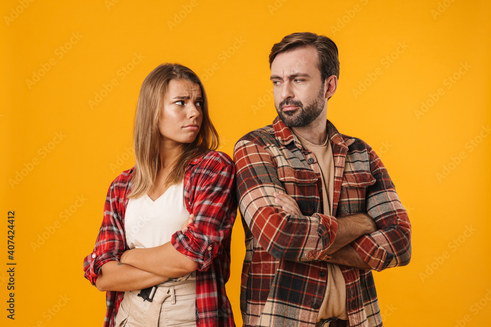 Obraz premium Charming unhappy couple posing with arms crossed