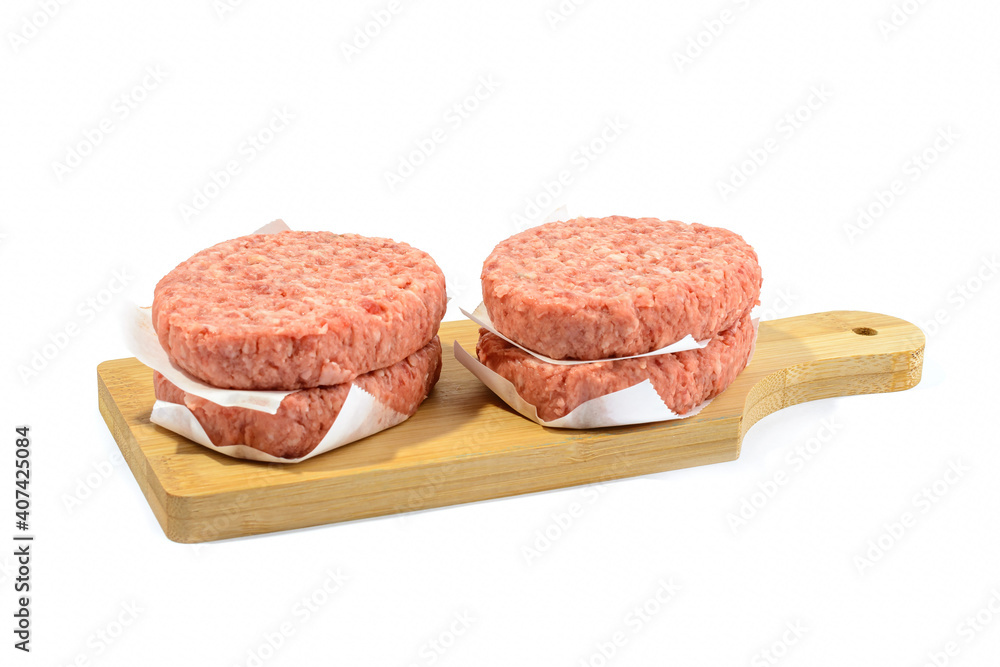 Raw beef patties for making a burger.Isolated on a white background. Raw beef patties for making a burger.Isolated on a white background.