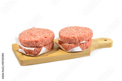 Raw beef patties for making a burger.Isolated on a white background.